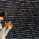 A student in the metaverse looking at a virtual chalkboard that's filled with code